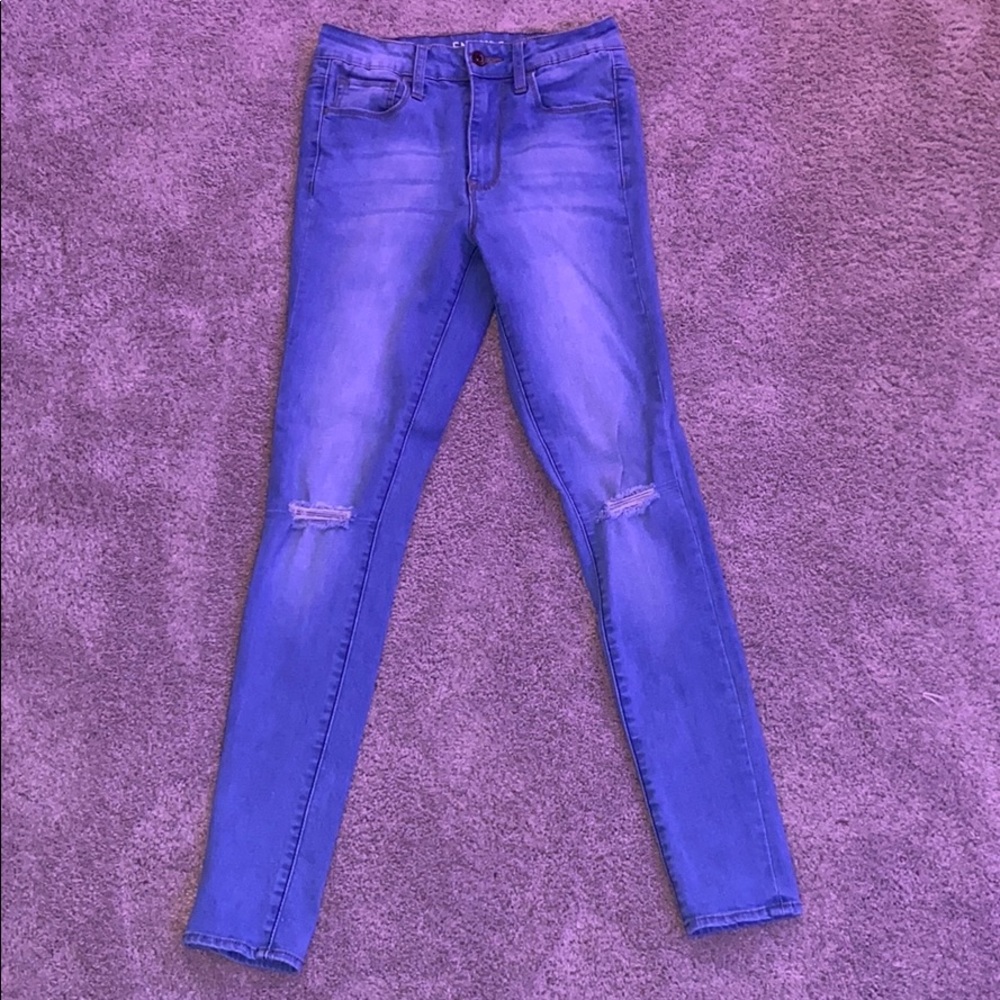 blue ripped jeans at the knee